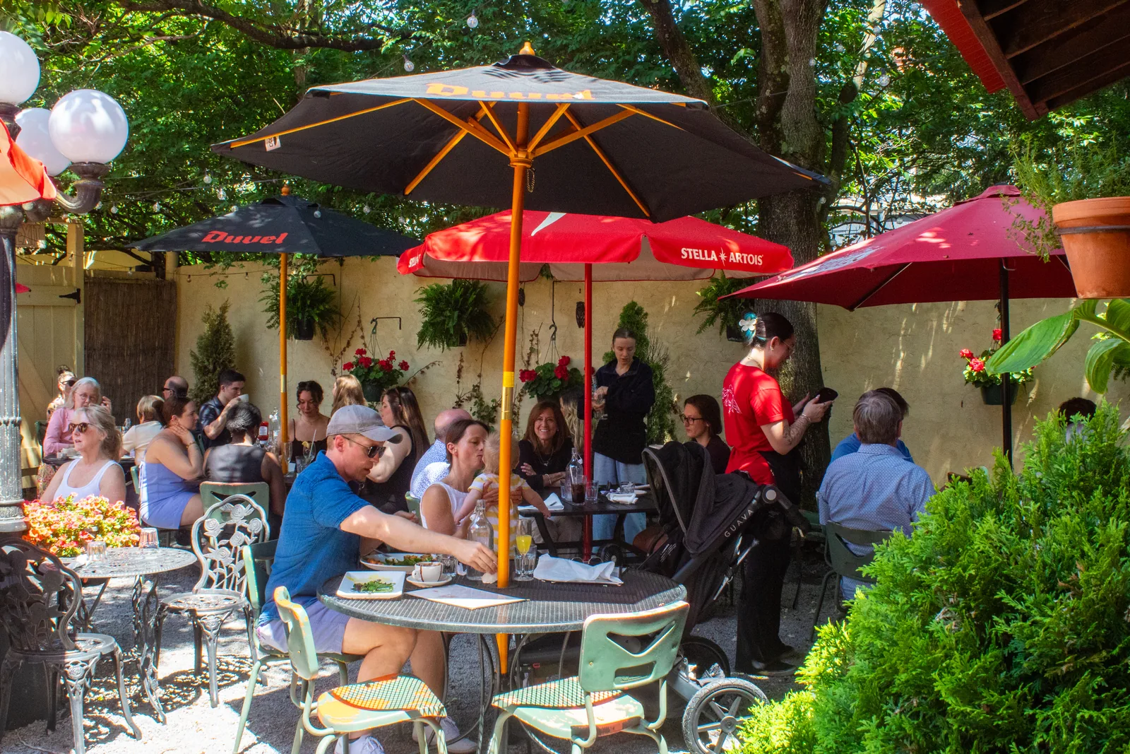 Sunny back patio with striped awning and umbrellas at Luca Bistro in Mt. Adams, Cincinnati